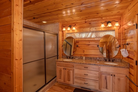 Bathroom with double sinks and a shower at Majestic Views, a 3 bedroom cabin rental located in Pigeon Forge