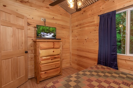 Bedroom with a chest of drawers and a TV at License to Chill, a 3 bedroom cabin rental located in Gatlinburg