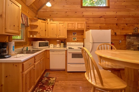 Kitchen with white appliances at Wild Crush, a 1 bedroom cabin rental located in Pigeon Forge
