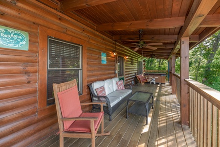 Plenty of seating on the covered deck at Grand View, a 3 bedroom cabin rental located in Sevierville