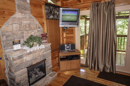 TV mounted in the corner of the living room at Seclusion, a 1 bedroom cabin rental located in Gatlinburg