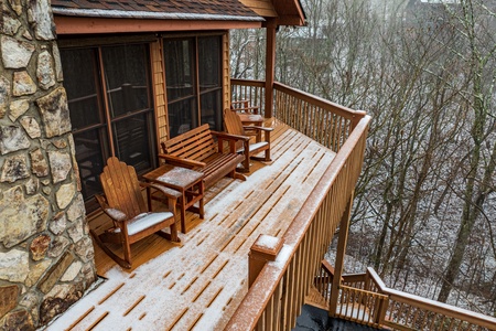 Adirondack rocker and loveseat glider on the open Snowy deck deck at Lazy Bear Retreat, a 4 bedroom cabin rental located in Pigeon Forge