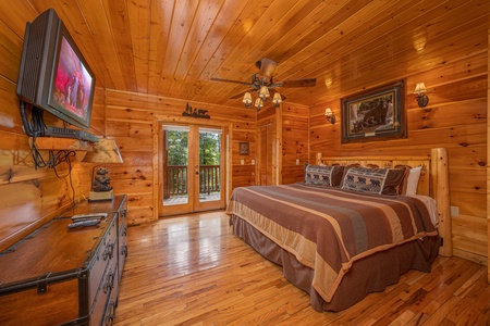King bedroom with TV at The Great Outdoors, a 3 bedroom cabin rental located in Pigeon Forge