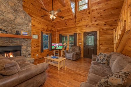 Living room with fireplace and TV at Family Getaway, a 4 bedroom cabin rental located in Pigeon Forge