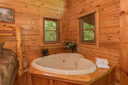 Heart-shaped jacuzzi in a bedroom at Dreams Do Come True, a 1-bedroom cabin rental located in Pigeon Forge