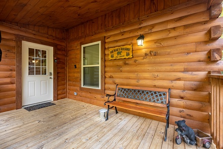 Front porch with bench at Gar Bear's Hideaway, a Pigeon Forge cabin rental