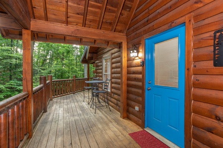 Bistro dining set next to the covered deck at Lazy Mountain Retreat, a 1 bedroom cabin rental located in Gatlinburg