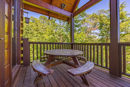 Round picnic table at Moonbeams & Cabin Dreams, a 3 bedroom cabin rental located in Pigeon Forge