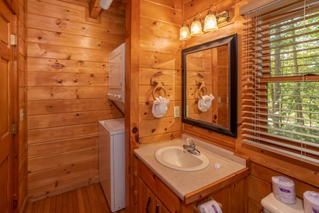 Bathroom with a stacked washer and dryer at Dreams Do Come True, a 1-bedroom cabin rental located in Pigeon Forge