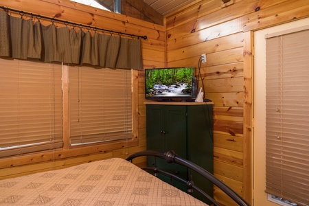Dresser and TV in a bedroom at Rustic Ranch, a 2 bedroom cabin rental located in Pigeon Forge