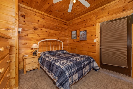 Bedroom with a night stand and a lamp at Family Getaway, a 4 bedroom cabin rental located in Pigeon Forge