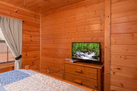 Flat screen tv in bedroom at Family Ties Lodge, a 4 bedroom cabin rental located in pigeon forge