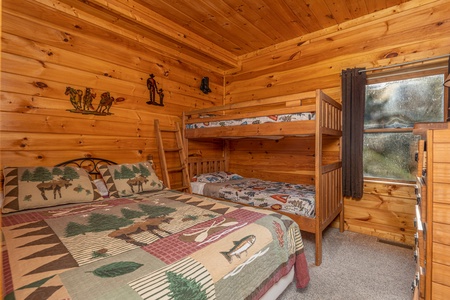 Bedroom with a king bed and two bunks at Family Getaway, a 4 bedroom cabin rental located in Pigeon Forge