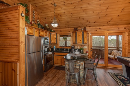 Kitchen with breakfast bar seating for four at Fowl Play, a 1 bedroom cabin rental located in Pigeon Forge