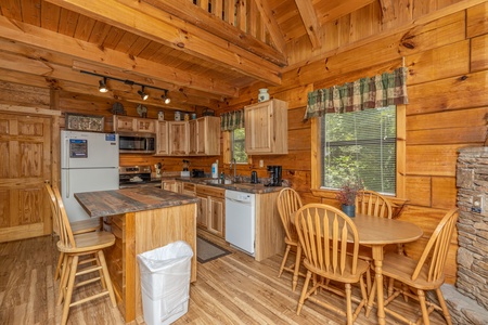 Kitchen and dining space at Honeymoon in Gatlinburg, a 1 bedroom cabin rental located in Gatlinburg