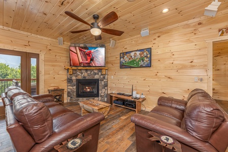 Game room seating, tv, and video game at Twin Peaks, a 5 bedroom cabin rental located in Gatlinburg