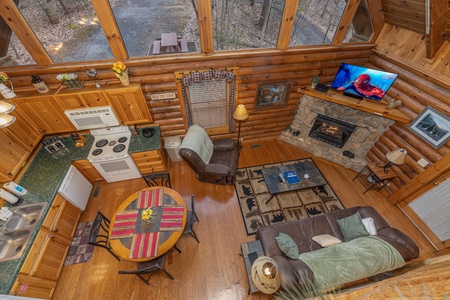 Looking down at the living, dining, and kitchen spaces at A Lover's Secret, a 1 bedroom cabin rental located in Gatlinburg