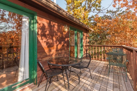 Two dining tables on the deck at Just for Fun, a 4 bedroom cabin rental located in Pigeon Forge