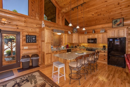 Kitchen with island and counter seating at Great View Lodge, a 5-bedroom cabin rental located in Pigeon Forge