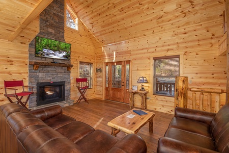 Living room with fireplace and TV at Pinot Splash, a 4 bedroom cabin rental located in Gatlinburg