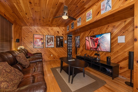 Lower level living room with seating and TV at Hatcher Mountain Retreat a 2 bedroom cabin rental located in Pigeon Forge