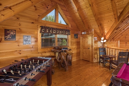 Foosball table in the game loft at Graceland, a 4-bedroom cabin rental located in Pigeon Forge