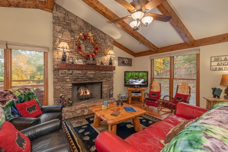 Fireplace and TV in a living room at Lazy Bear Retreat, a 4 bedroom cabin rental located in Pigeon Forge