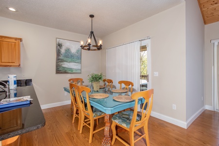 Dining table with seating for six at Into the Woods, a 3 bedroom cabin rental located in Pigeon Forge