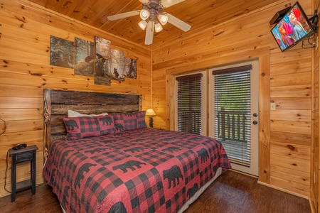 King bed and deck access at Loving Every Minute, a 5 bedroom cabin rental located in Pigeon Forge