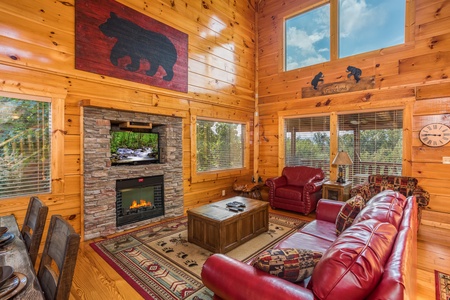 Living room with fireplace and TV at Graceland, a 4-bedroom cabin rental located in Pigeon Forge