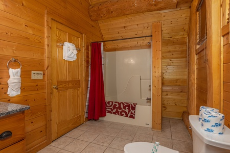 Bathroom with a tub and shower at Grizzly's Den, a 5 bedroom cabin rental located in Gatlinburg