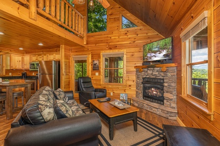 Living room with fireplace, TV, sofa, chairs at Moonlit Pines, a 2 bedroom cabin rental located in Pigeon Forge