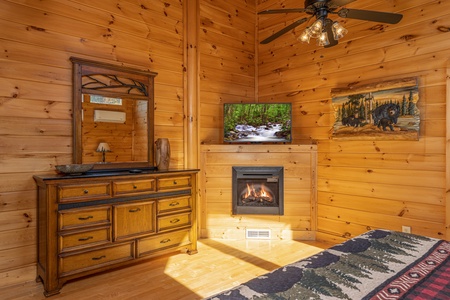 Dresser, fireplace, and TV in a bedroom at Bears Don't Bluff, a 3 bedroom cabin rental located in Pigeon Forge