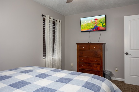 Bedroom with dresser and flat screen at Hoop Dreams Lodge