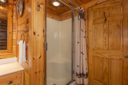 Shower next to a jacuzzi tub at A Lover's Secret, a 1 bedroom cabin rental located in Gatlinburg