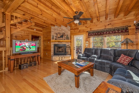 TV, fireplace and sectional sofa in a living room at Sensational Views, a 3 bedroom cabin rental located in Gatlinburg