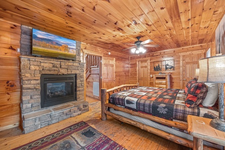 Fireplace and TV in a bedroom at Moonshine Memories, a 2 bedroom cabin rental located in Gatlinburg
