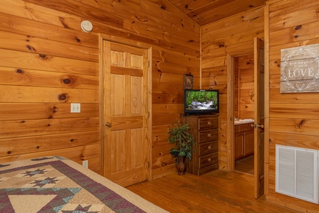 Dresser and TV in a bedroom at A Cheerful Heart, a 2 bedroom cabin rental located in Pigeon Forge