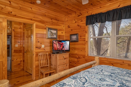 Bedroom with dresser and TV at Hickernut Lodge, a 5-bedroom cabin rental located in Pigeon Forge