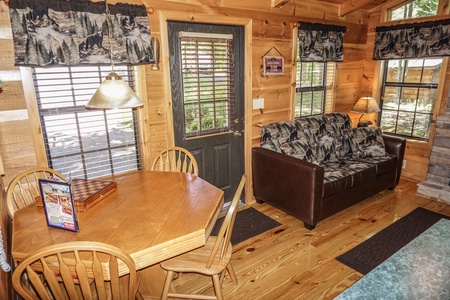 Dining area doubles as a game table at Seclusion, a 1 bedroom cabin rental located in Gatlinburg