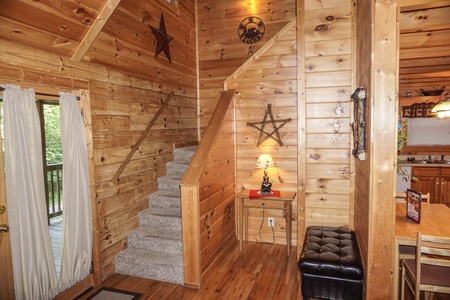 Staircase up to second floor at Bearly Mine, a 1-bedroom cabin rental located in Pigeon Forge