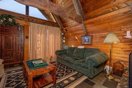 Front door and couch at Ever After, a 1 bedroom cabin rental located in Gatlinburg