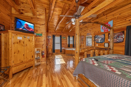 Armoire, TV, and jacuzzi in a bedroom at Nascar Nation, a 2 bedroom cabin rental located in Pigeon Forge