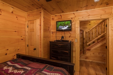 Dresser and TV in a bedroom at Graceland, a 4-bedroom cabin rental located in Pigeon Forge