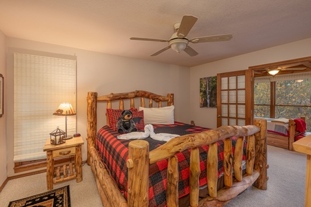 Bedroom with a log bed and separate sleeping area at Lazy Bear Retreat, a 4 bedroom cabin rental located in Pigeon Forge