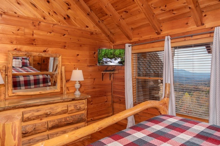 Bedroom with wall mounted television and mountain view at The Original American Dream, a 2 bedroom cabin rental located in Gatlinburg