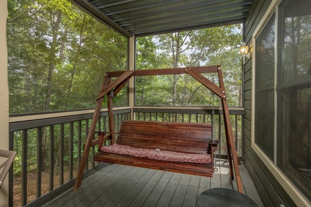 Swing on a covered porch at Amazing Memories, a 3 bedroom cabin rental located in Pigeon Forge