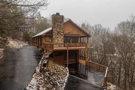 Driveway, front, and side of the cabin in winter at Lazy Bear Retreat, a 4 bedroom cabin rental located in Pigeon Forge