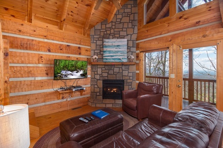 Living room with fireplace and TV at Ella-Vation, a 3 bedroom cabin rental located in Gatlinburg