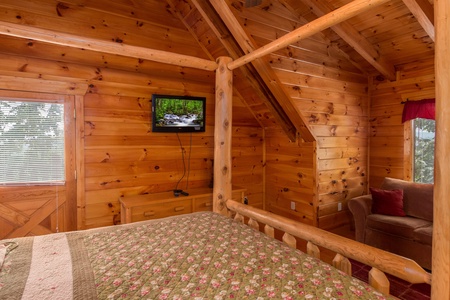 Bedroom with a TV and couch at A Beautiful Memory, a 4 bedroom cabin rental located in Pigeon Forge